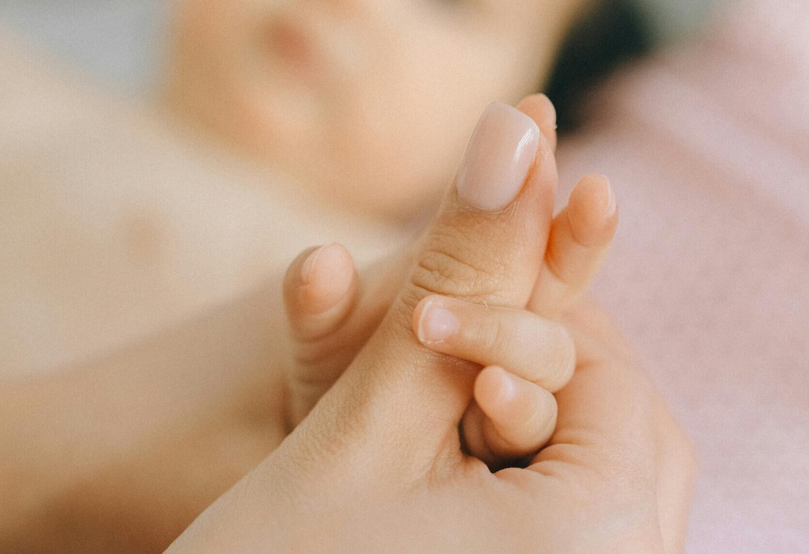 eine erwachsenen hand hält die Hand eines Babys